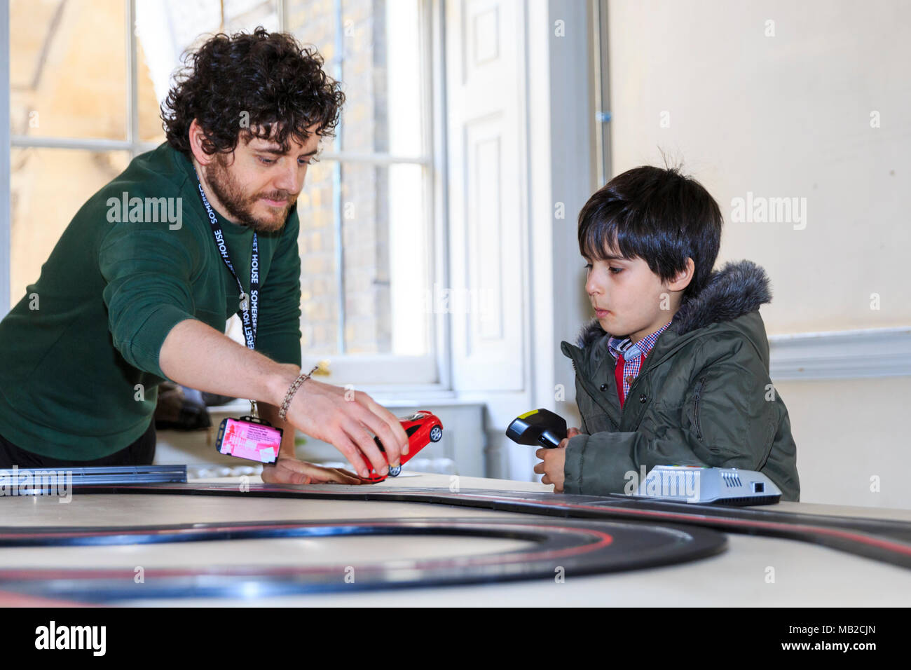 Somerset House, London, 6th April 2018. Yara El-Sherbini's 'Roadmap to Peace' represents two roads in Israel and Palestine, but can also be enjoyed at a more simple level by visiting children - and this young boy is clearly fascinated. Visitors, particularly children, enjoy interacting with the games. Now Play This is an interactive exhibition and festival of game design opening today at Somerset House in Central London. Credit: Imageplotter News and Sports/Alamy Live Newss Stock Photo