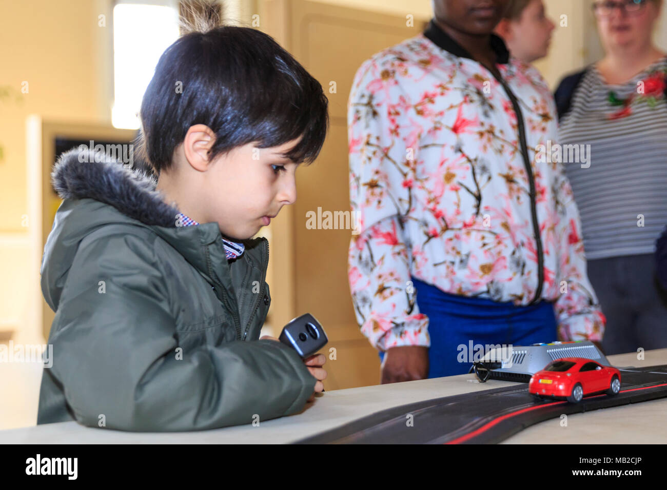 Somerset House, London, 6th April 2018. Yara El-Sherbini's 'Roadmap to Peace' represents two roads in Israel and Palestine, but can also be enjoyed at a more simple level by visiting children - and this young boy is clearly fascinated. Visitors, particularly children, enjoy interacting with the games. Now Play This is an interactive exhibition and festival of game design opening today at Somerset House in Central London. Credit: Imageplotter News and Sports/Alamy Live News Stock Photo