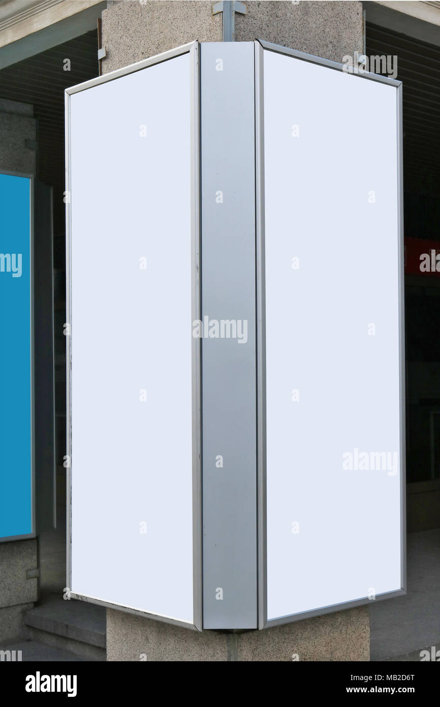 Metal vertical advertising boards are fixed on a concrete column. Emty ...