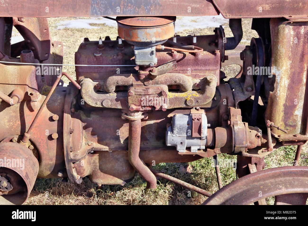 Abstract background from chaos and weaving of rusty metal engine  parts of vintage agricultural tracror. Sunny day outdoor shot Stock Photo