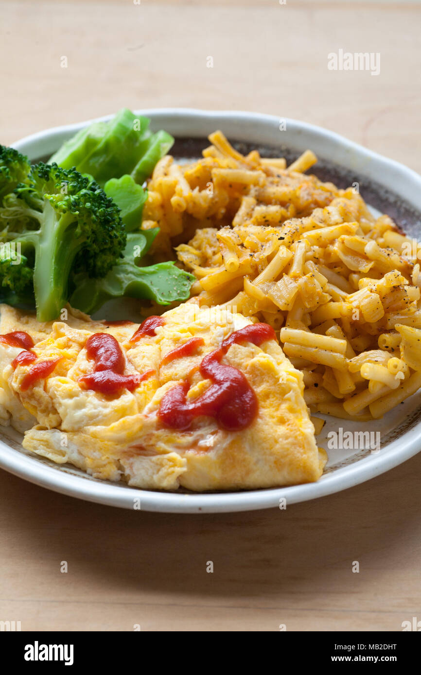 Egg, broccoli, macaroni and cheeese lunch plate on the table Stock Photo