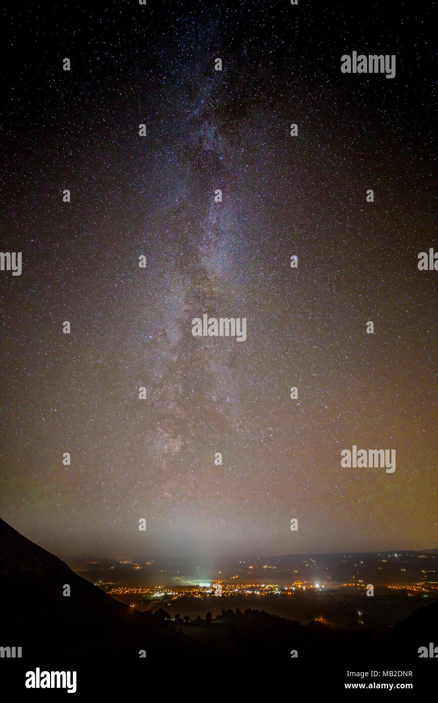 Milky Way over the town lights of Ruthin at night, North Wales Stock Photo