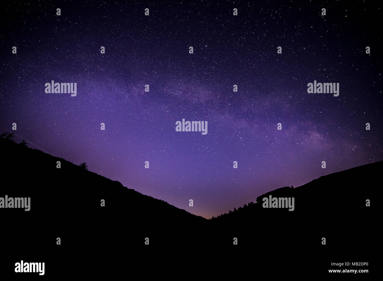 Milky Way arching over the Clwydian Forest at Moel Famau, North Wales Stock Photo