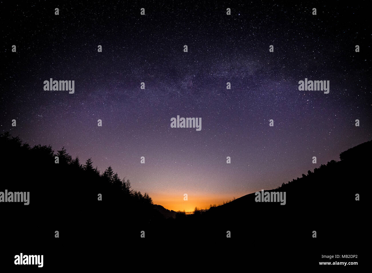 Milky Way arching over the Clwydian Forest at Moel Famau, North Wales Stock Photo