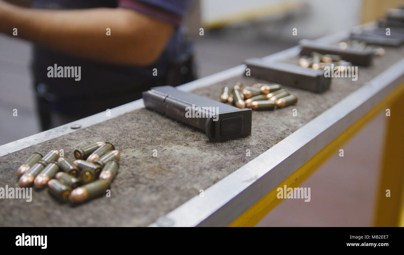 Pistol clips with bullets in shooting gallery Stock Photo Alamy