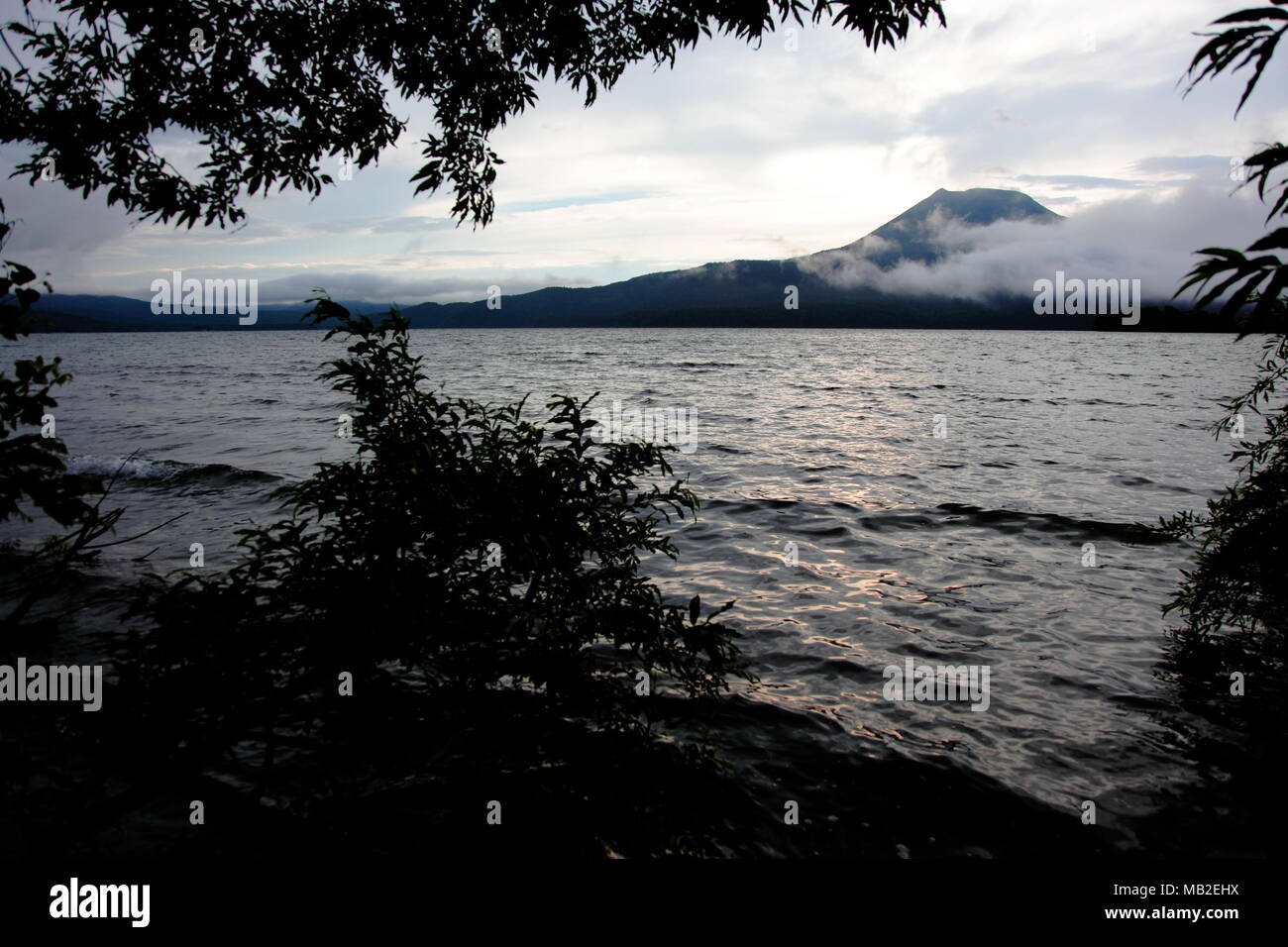 Mt. Akan rising in the lake Stock Photo