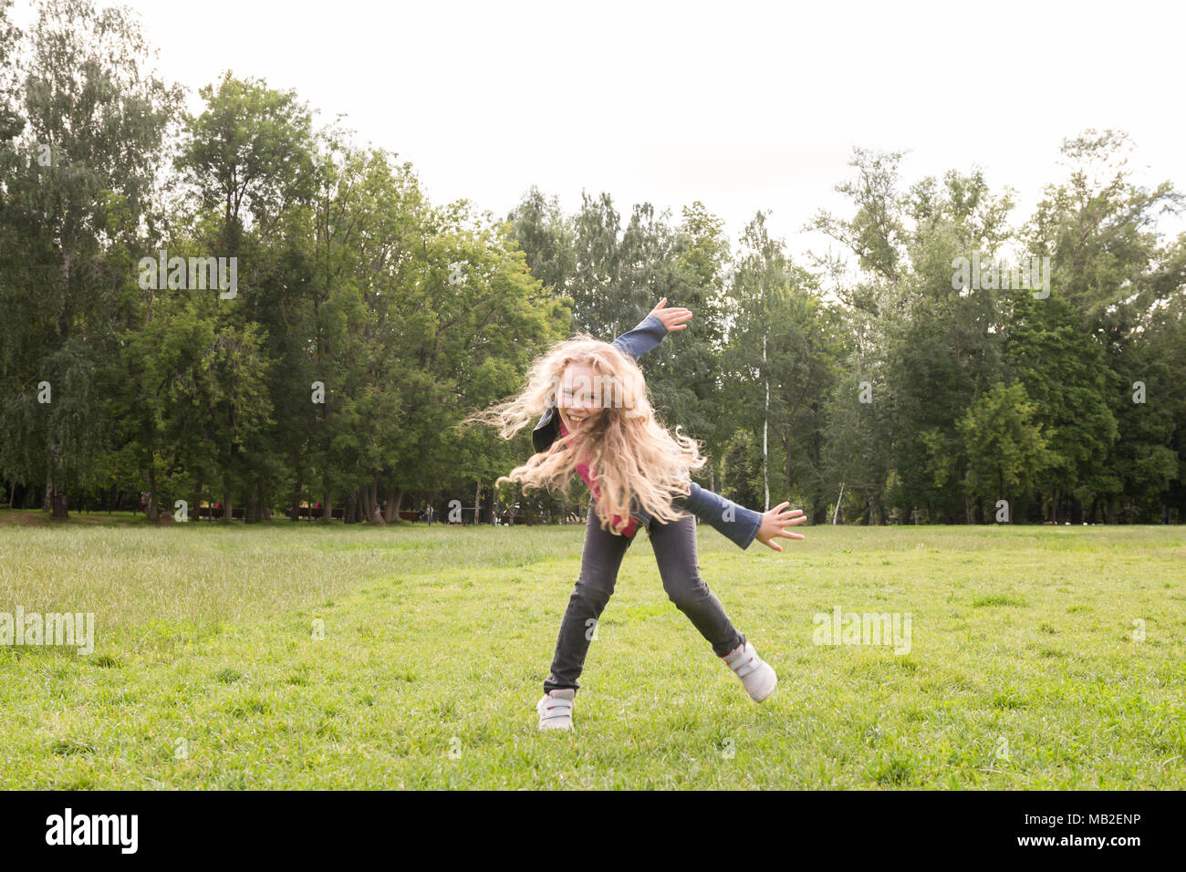 Pretty smiling child posing in park Stock Photo - Alamy