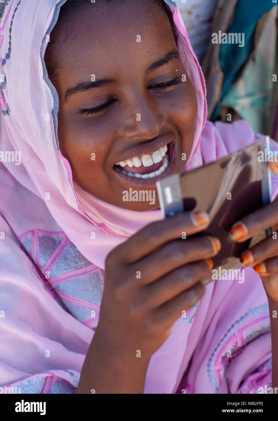 Portrait of a somali young woman dicvovering herself on a polaroid picture, North-Western province, Berbera, Somaliland Stock Photo