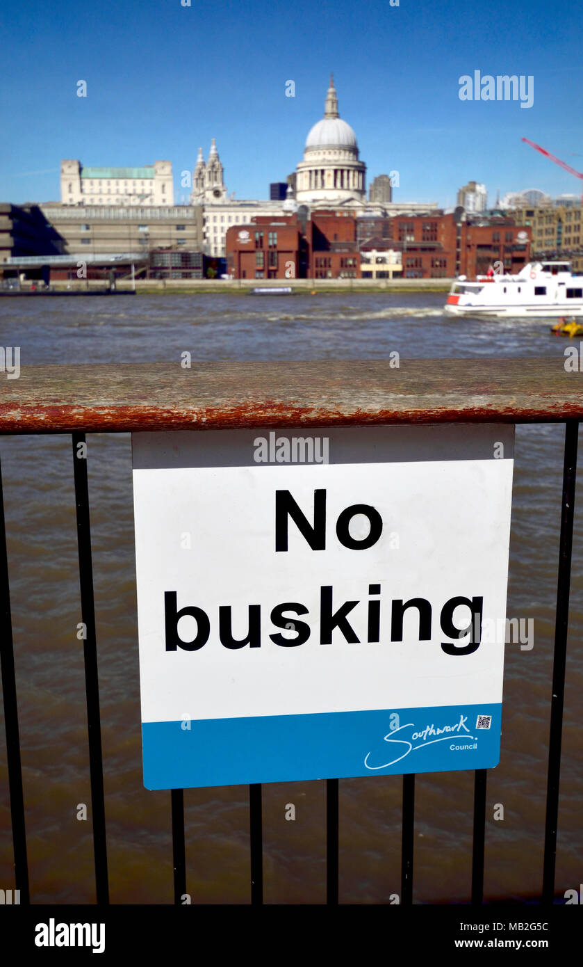 London, England, UK. No Busking sign on the South Bank, across the river from St Paul's Cathedral Stock Photo