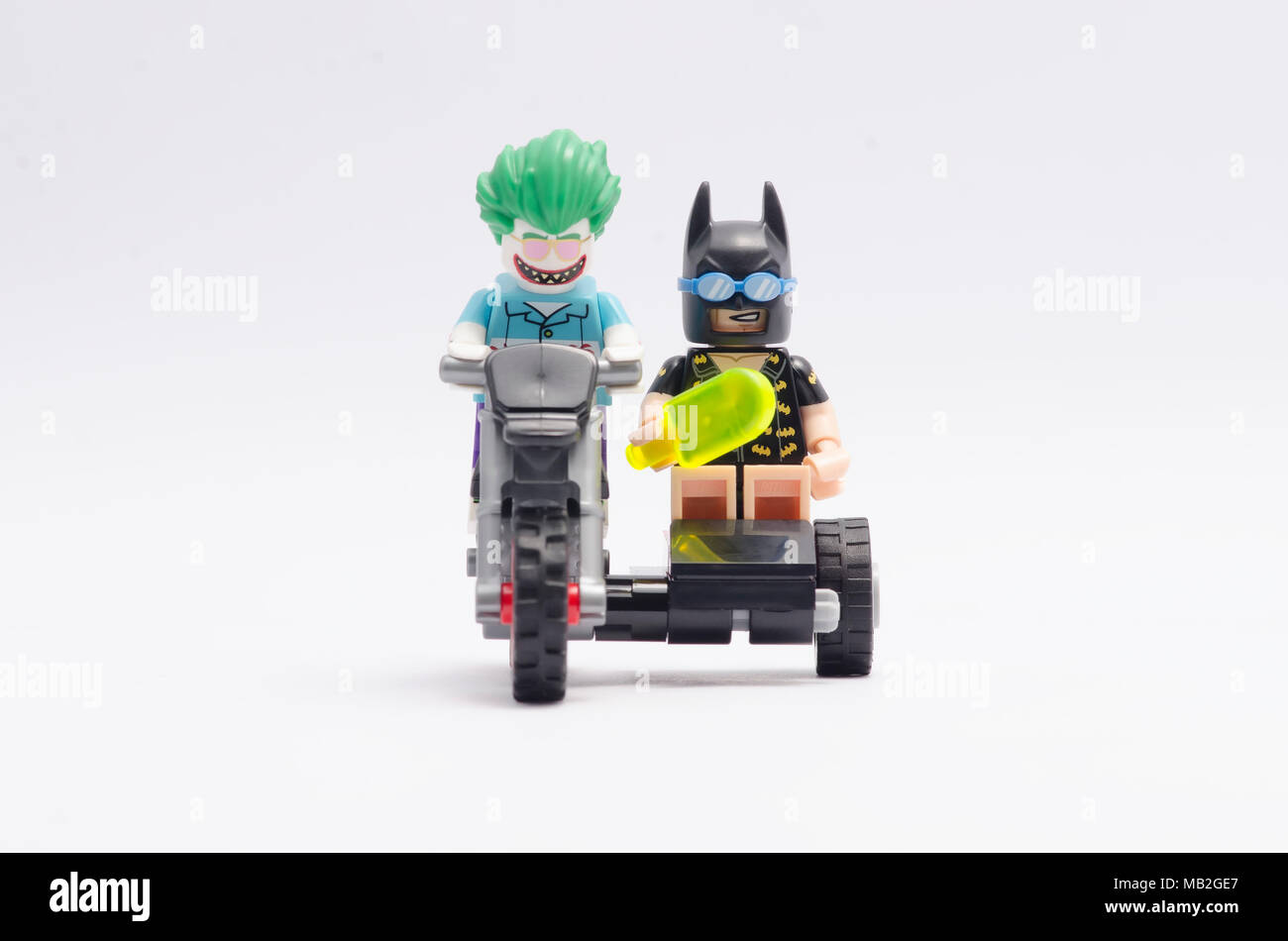 Lego Joker And Batman Riding Motorcycle Isolated On White Background