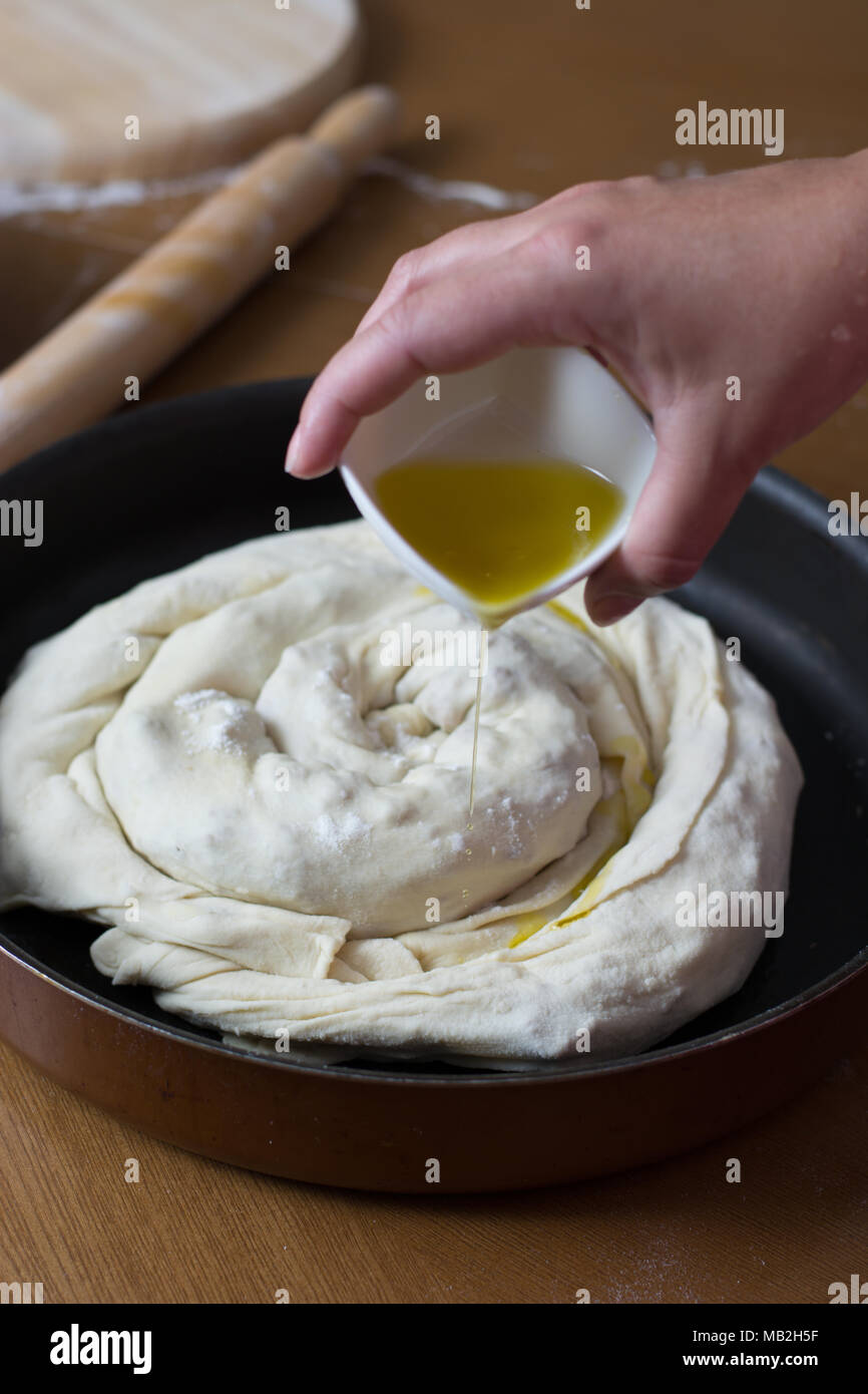 Woman making dough with meat at home on the kitchen table Stock Photo