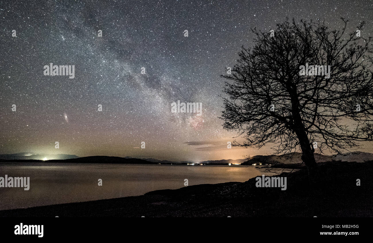 The Milky Way and Andromeda rising over the Highlands of Scotland Stock Photo