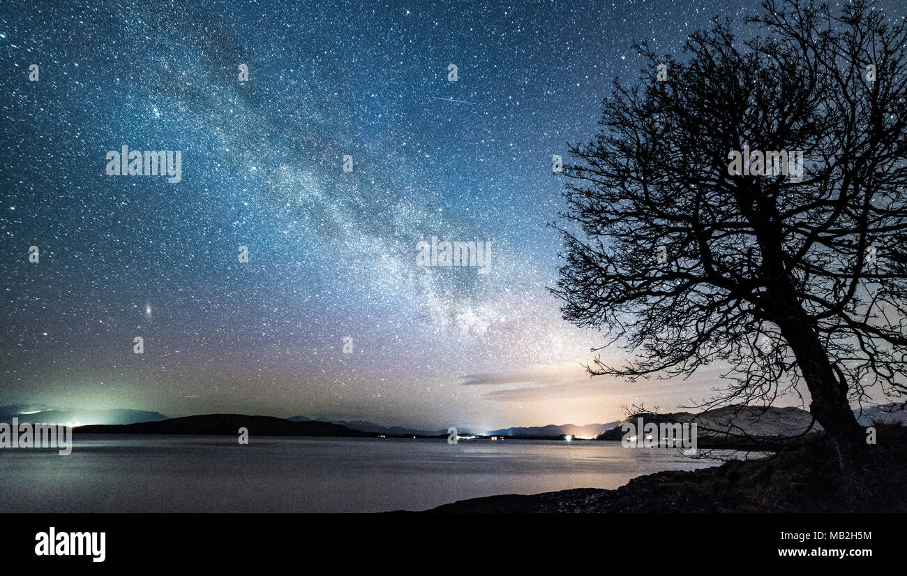 The Milky Way and Andromeda rising over the Highlands of Scotland Stock Photo