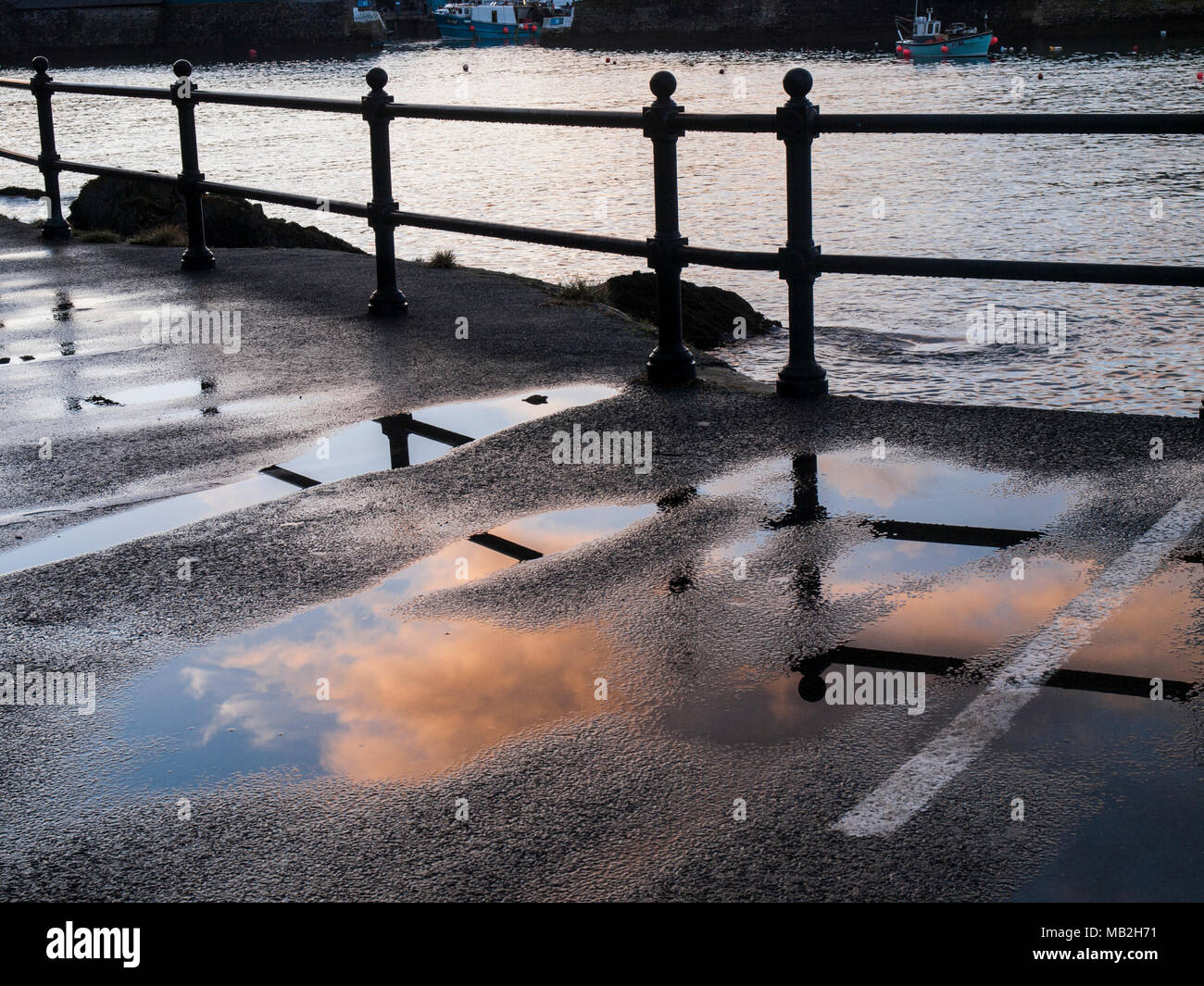Mevagissey harbour. Railings silhouettes. Reflections of clouds Stock ...