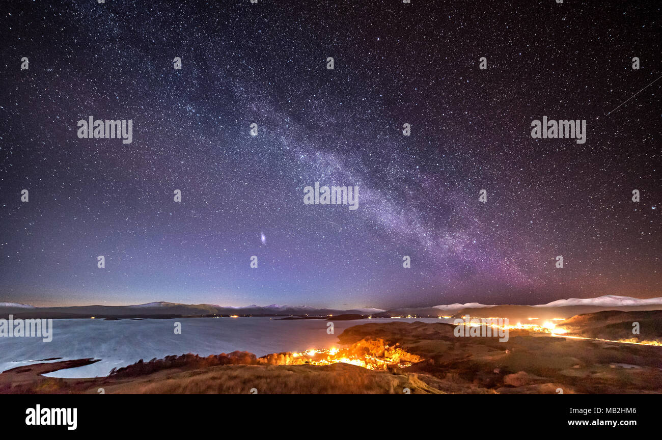 The Milky Way and Andromeda rising over the Highlands of Scotland Stock Photo