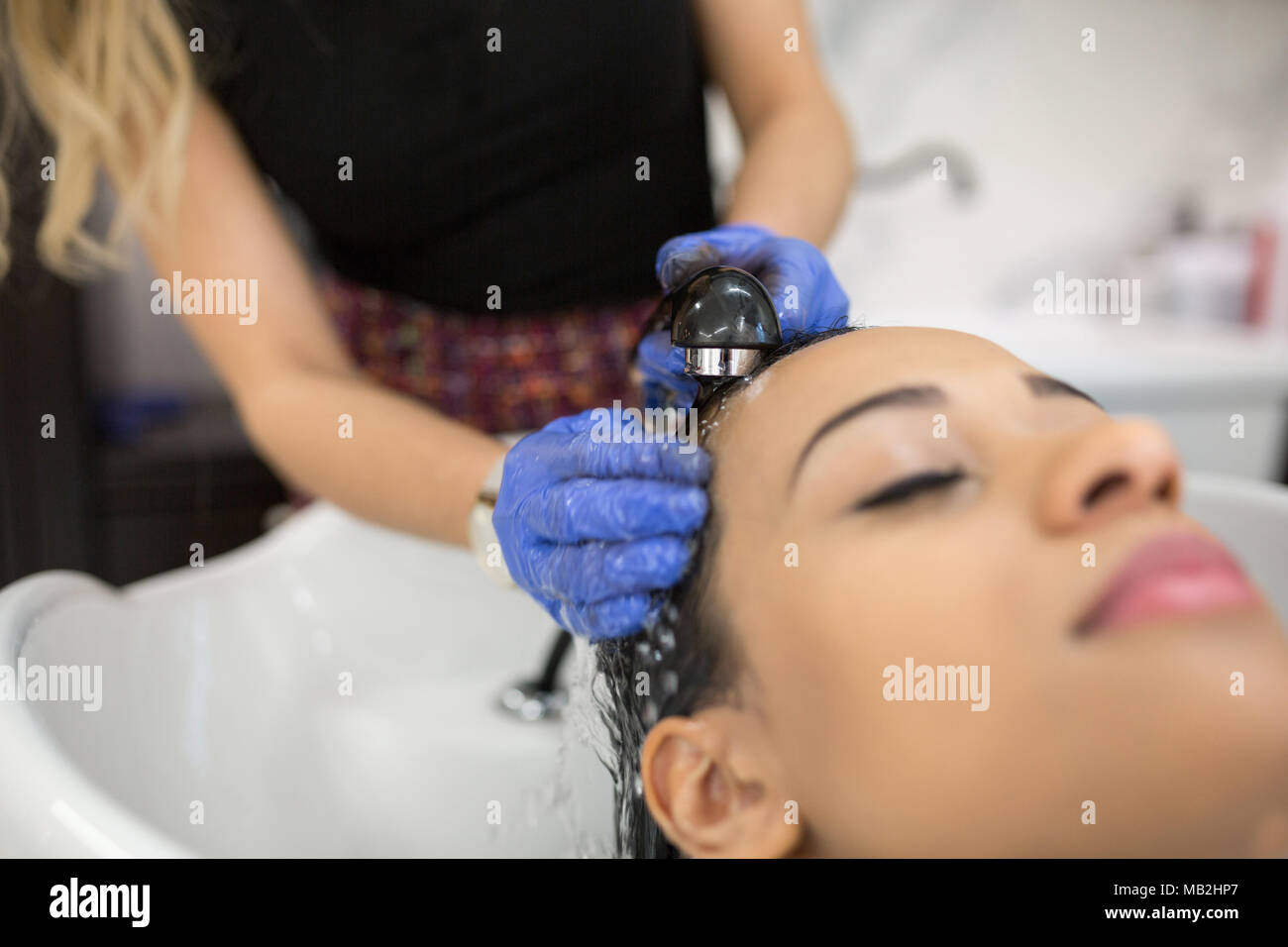 Close Up Portrait Of Relaxed Woman Having Hair Washed At