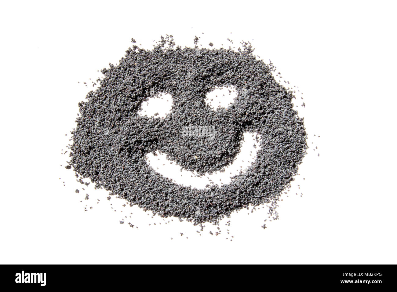 happy face made from dried poppy seeds Stock Photo Alamy