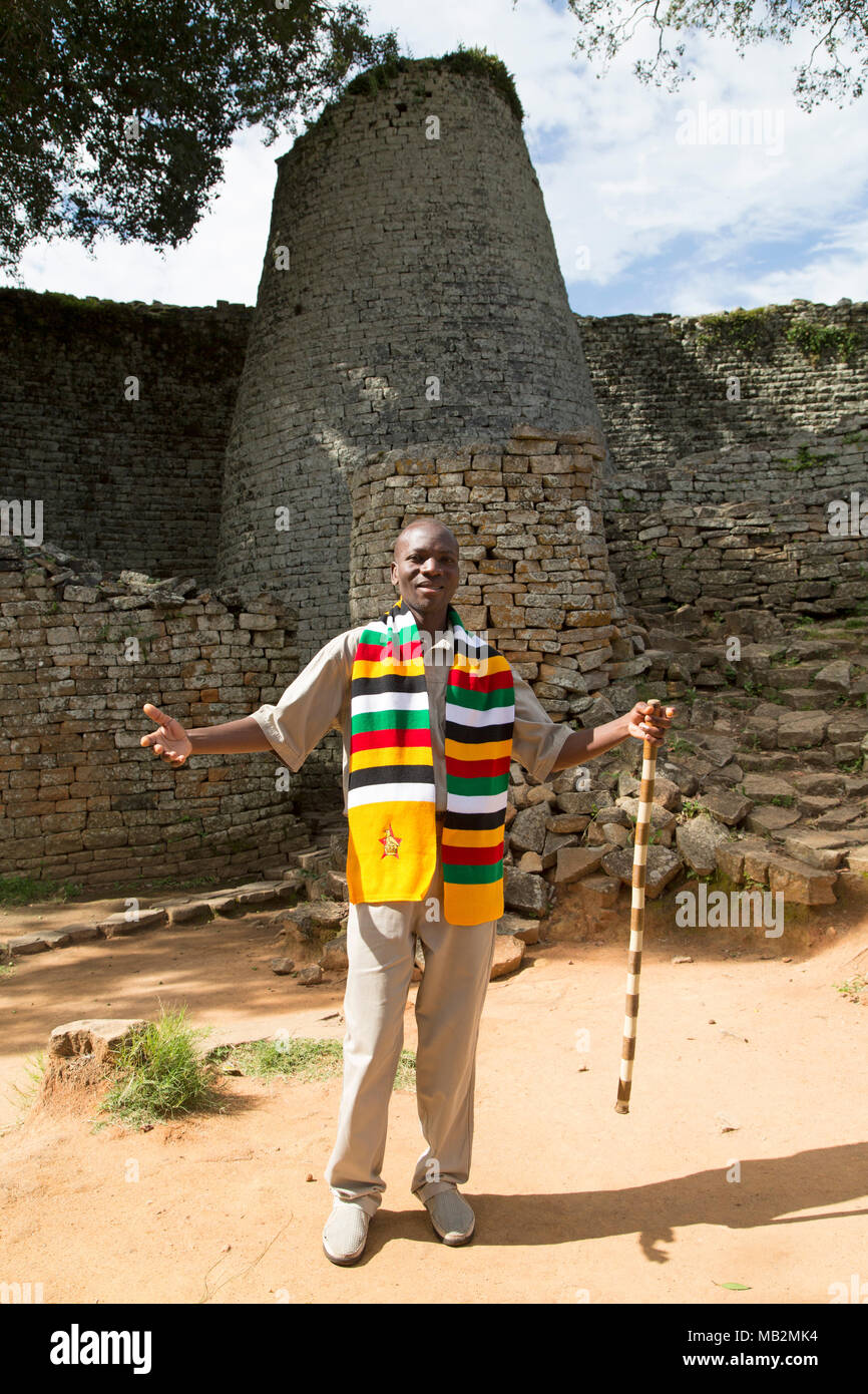 Lovemore, a guide at Great Zimbabwe near Masvingo in Zimbabwe. He explains about the stonework buildings that were the capital of the Kingdom of Zimba Stock Photo
