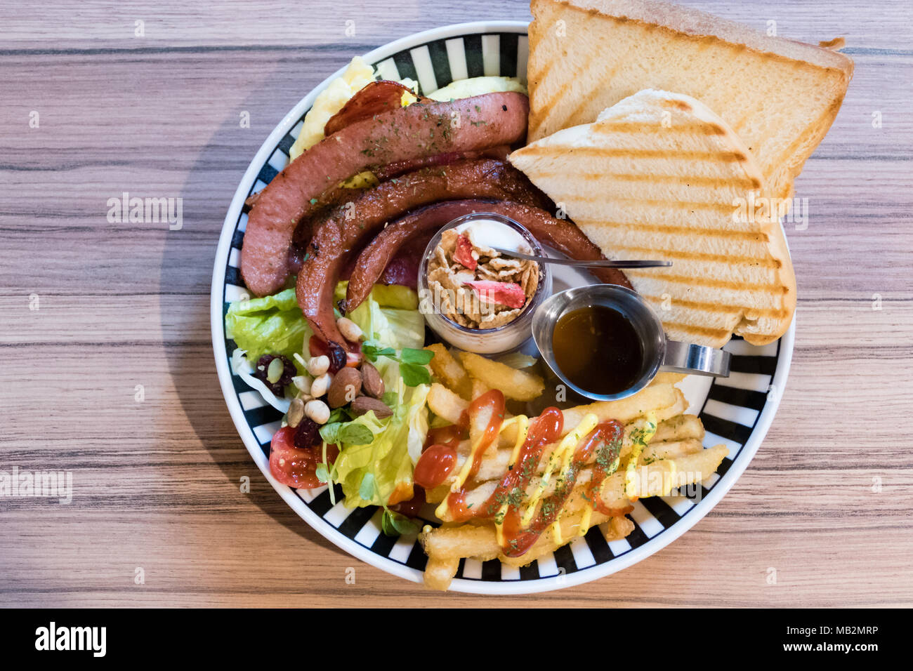 Brunch with german sausage, cereal, French fries, salad and toast shot