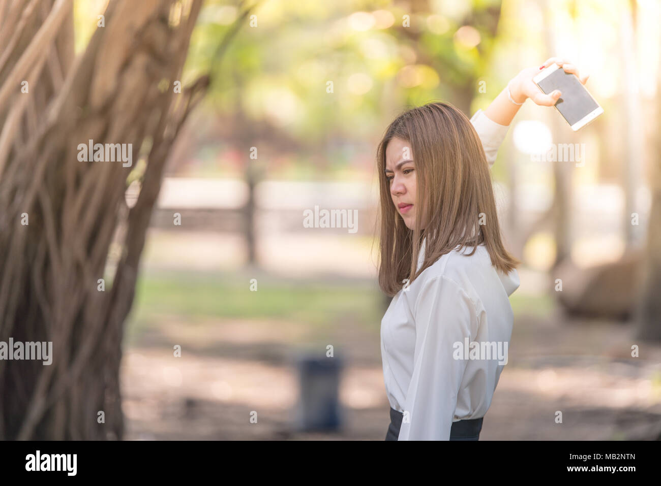angry young woman throwing a mobile phone Stock Photo Alamy