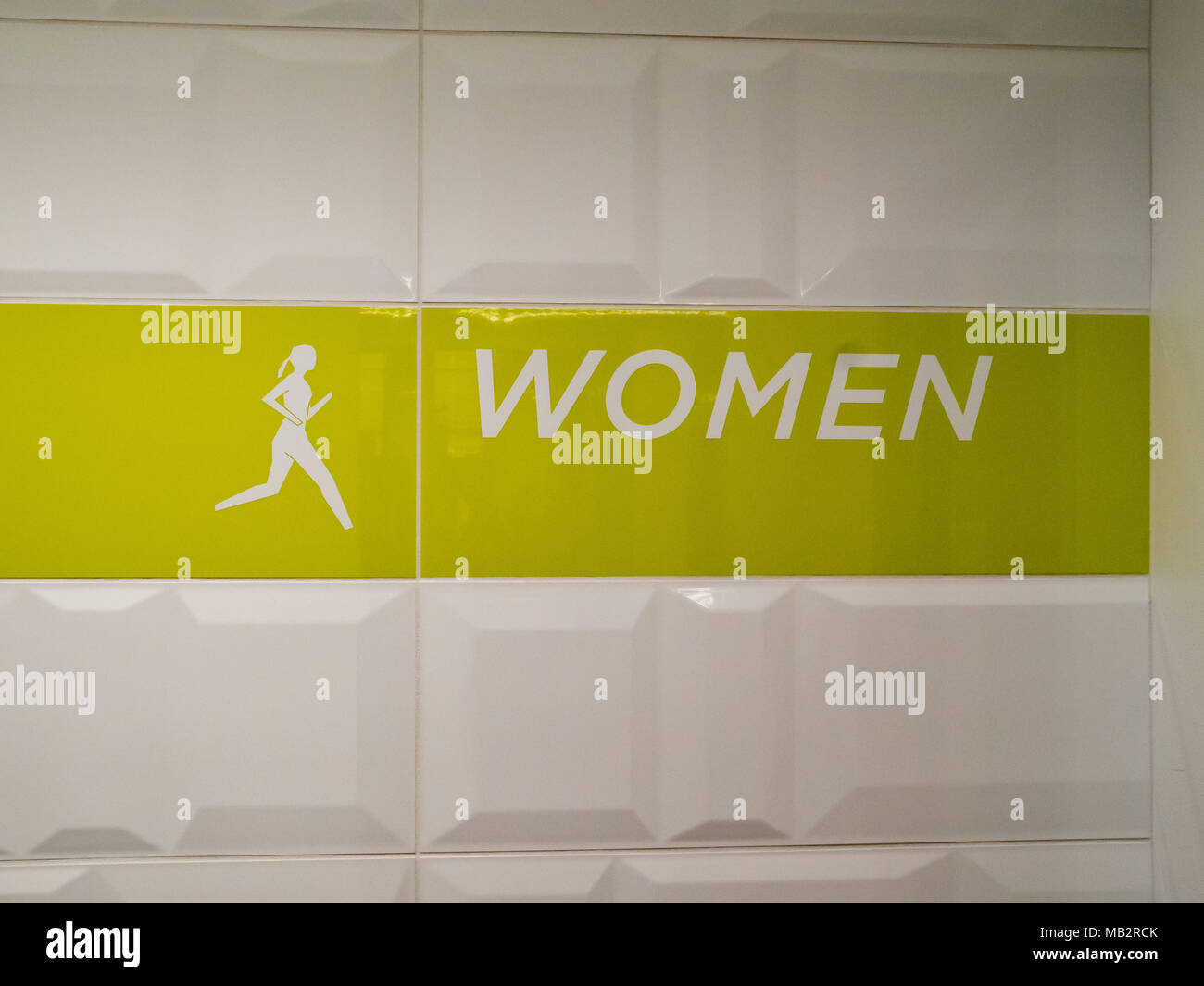 Woman's locker room entrance sign in modern office setting Stock Photo