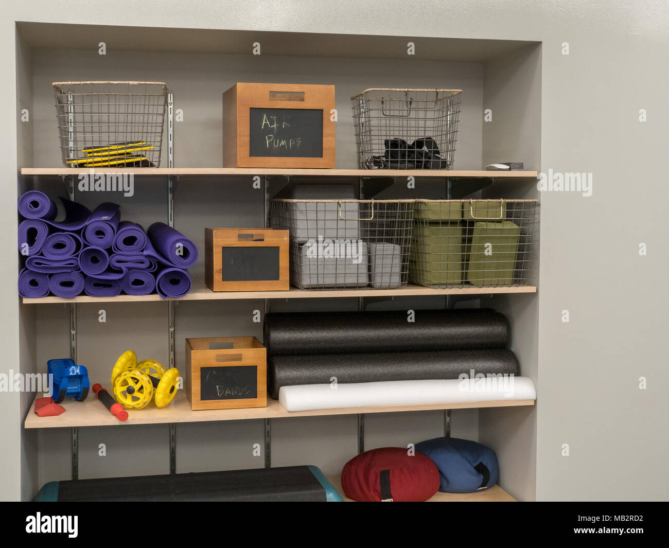 Shelf of work out equipment in modern gym. Yoga, classes