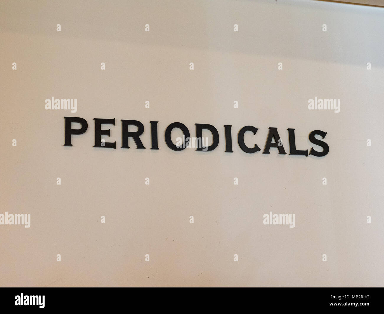 Library periodicals sign against white wall Stock Photo