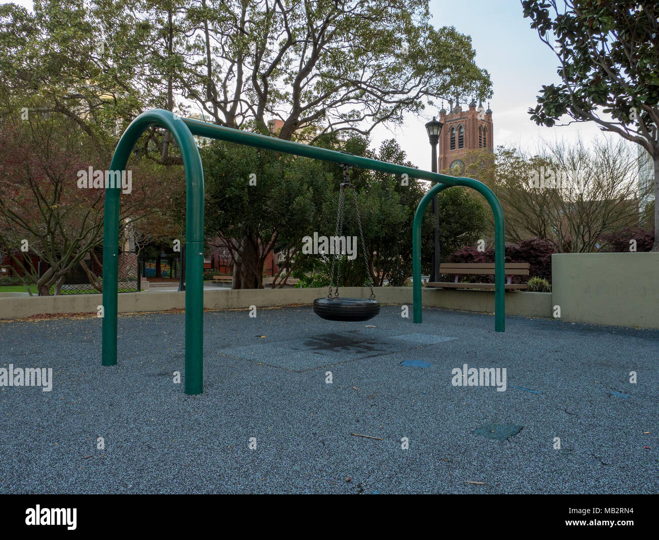 Tire swing in urban playground Stock Photo Alamy