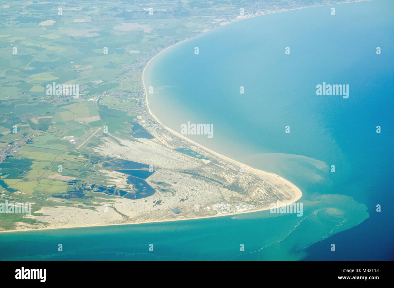 Aerial view of Dungeness headland jutting into the English Channel at Kent, England.  Towards the bottom is the Dungeness nuclear power station and to Stock Photo