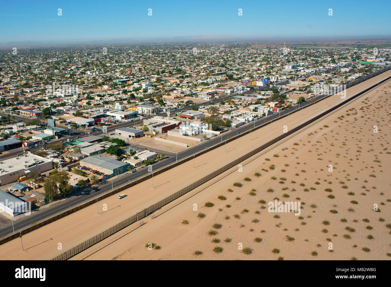 AERIAL VIEW. International border between Mexico and the United States. City of San Luis Rio Colorado in Sonora, stretching alongside the U.S. Border. Stock Photo