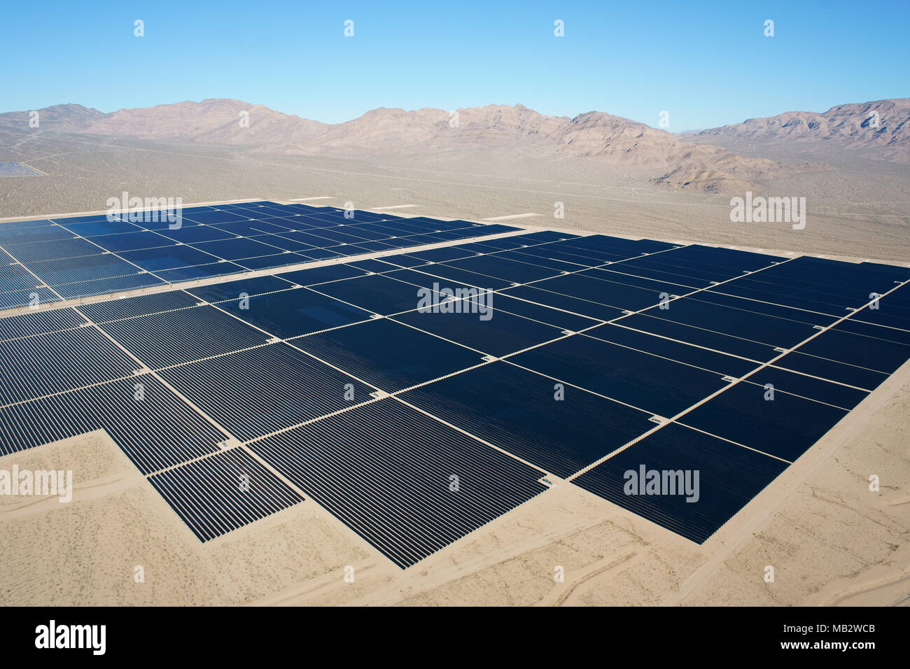 LARGE FIELD OF PHOTOVOLTAIC PANELS IN A DESERTIC LANDSCAPE (aerial view). Nipton, Mojave Desert, San Bernardino County, California, USA. Stock Photo