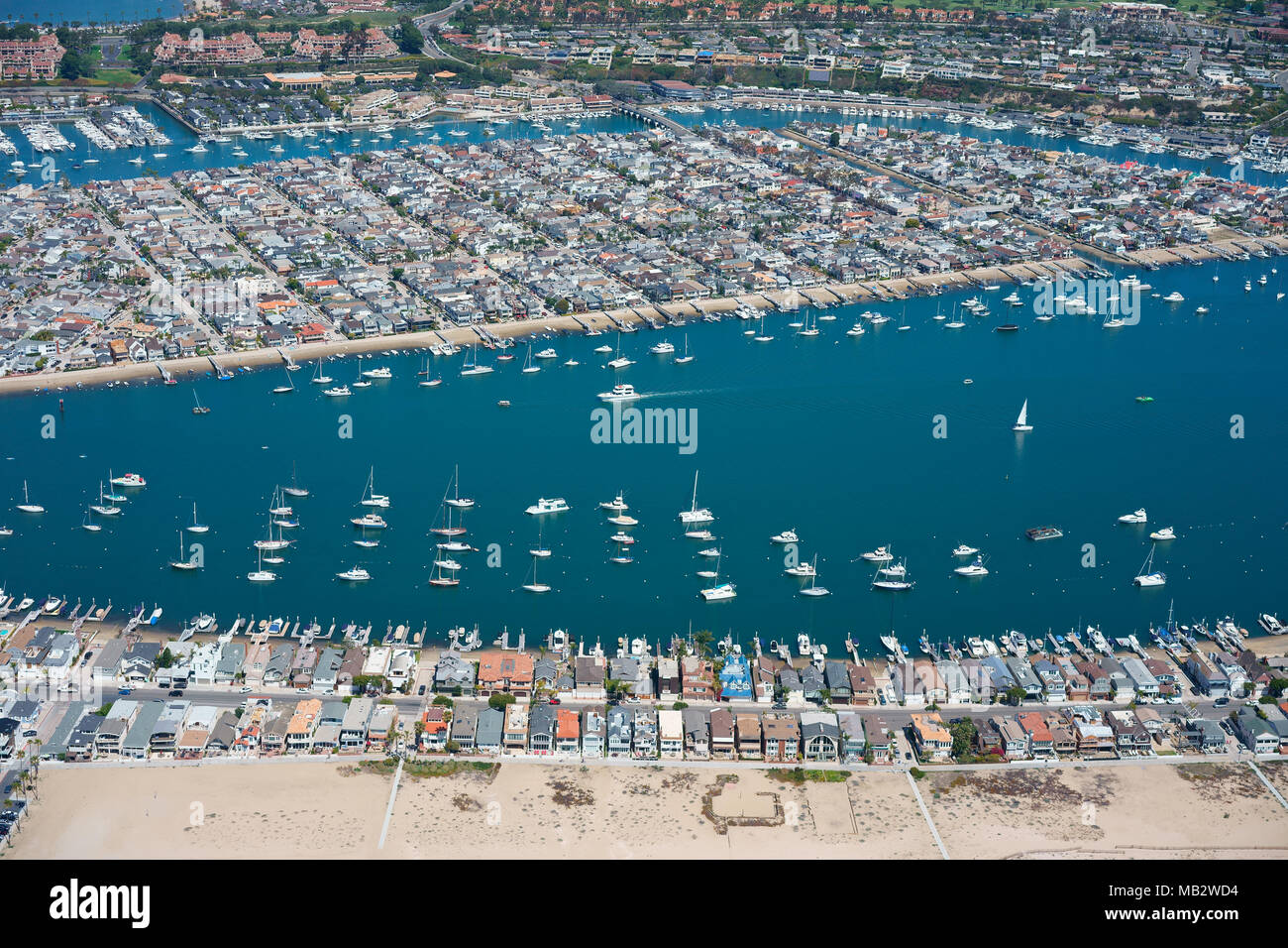 AERIAL VIEW. Balboa Peninsula in the foreground with Balboa Island behind. Newport Beach, Orange County, California, USA. Stock Photo