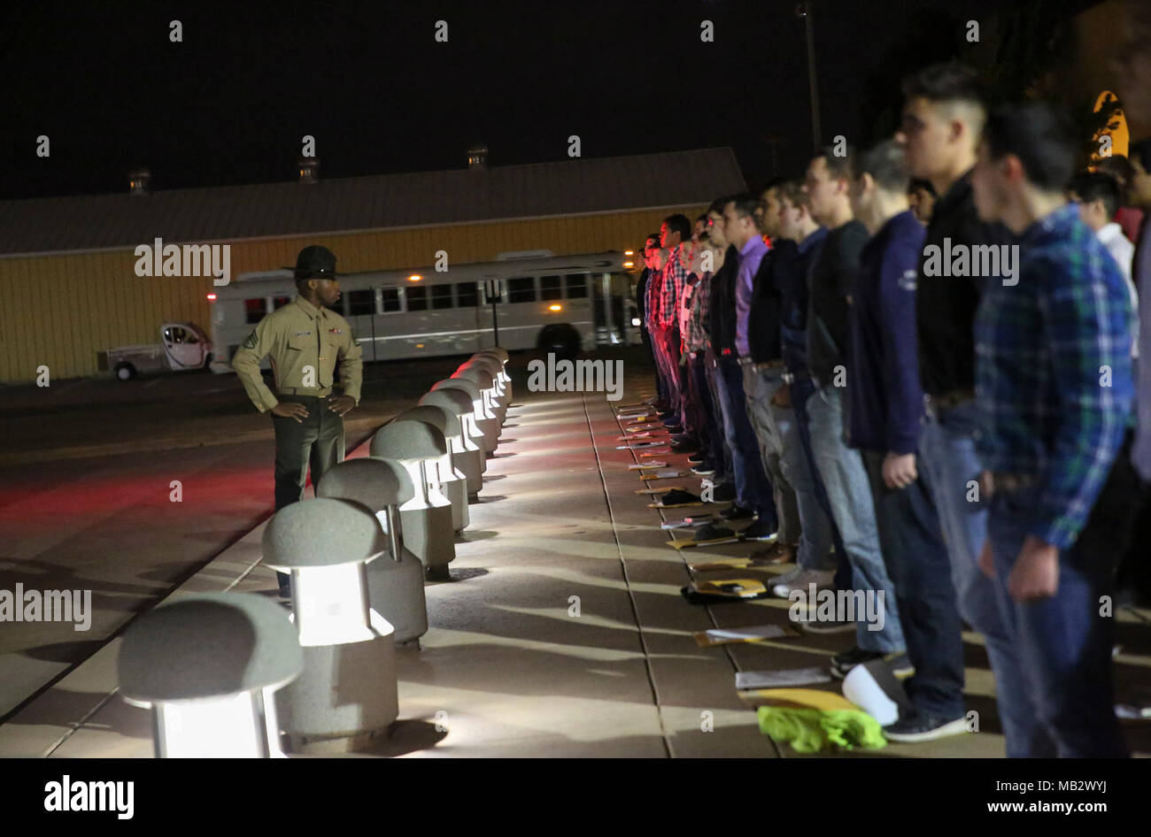 New recruits with Echo Company, 2nd Recruit Training Battalion, stand on yellow footprints during receiving at Marine Corps Recruit Depot San Diego, Feb. 12. From this point on, recruits will eat, sleep and train as a team as they begin the transformation from civilian to Marine. Annually, more than 17,000 males recruited from the Western Recruiting Region are trained at MCRD San Diego. Echo Company is scheduled to graduate May 11. Stock Photo