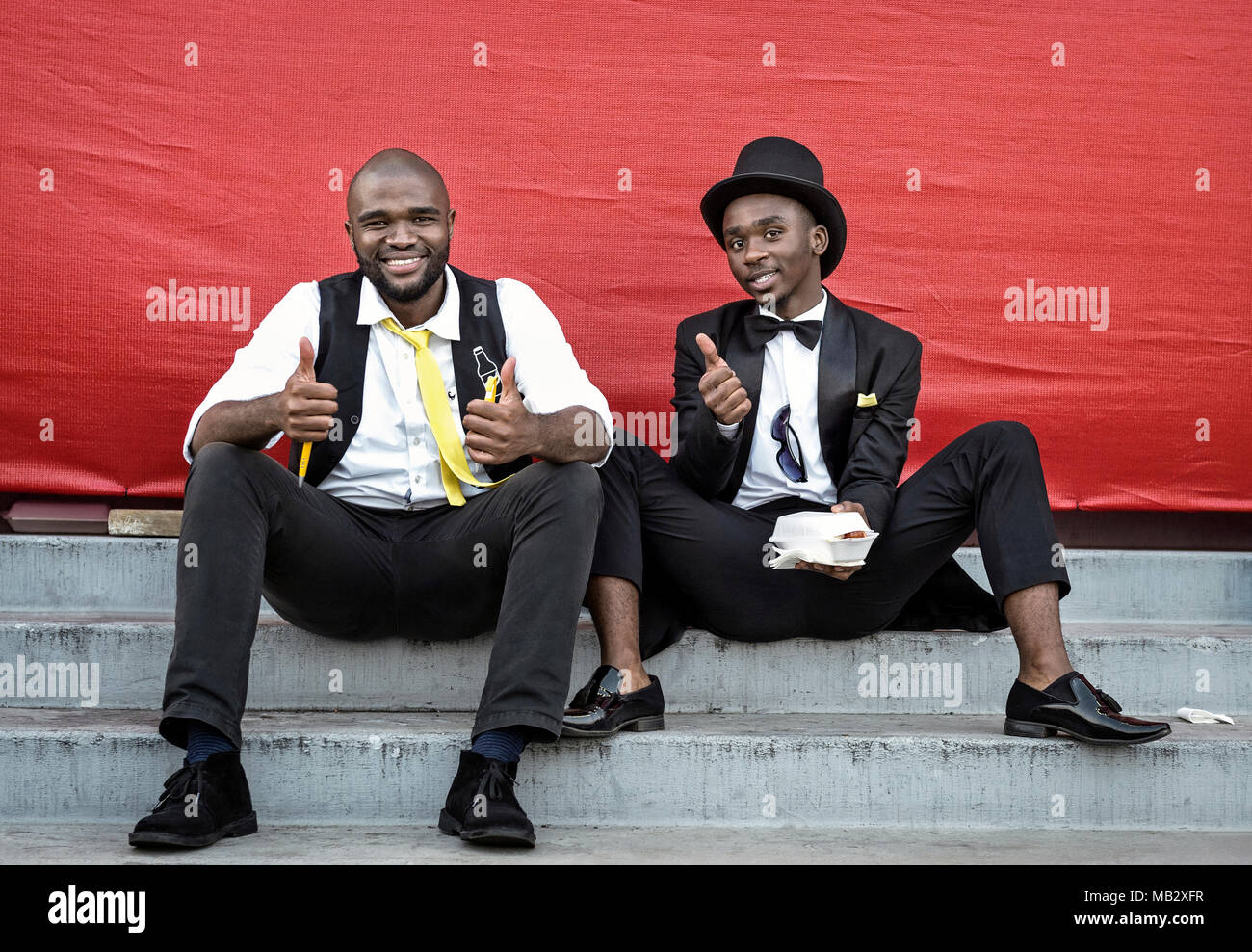 DURBAN, SOUTH AFRICA – June 1, 2017: Two young men in happy mood at the Durban July Horserace in South Africa. Stock Photo