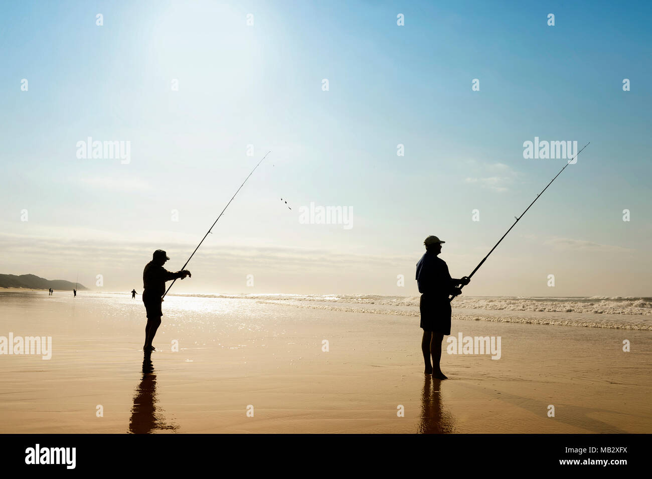 Durban, South Africa - 25. June 2017: Fisherman fishing on a beach alone in St. Lucia, Hluhluwe National Park, near Durban. Stock Photo