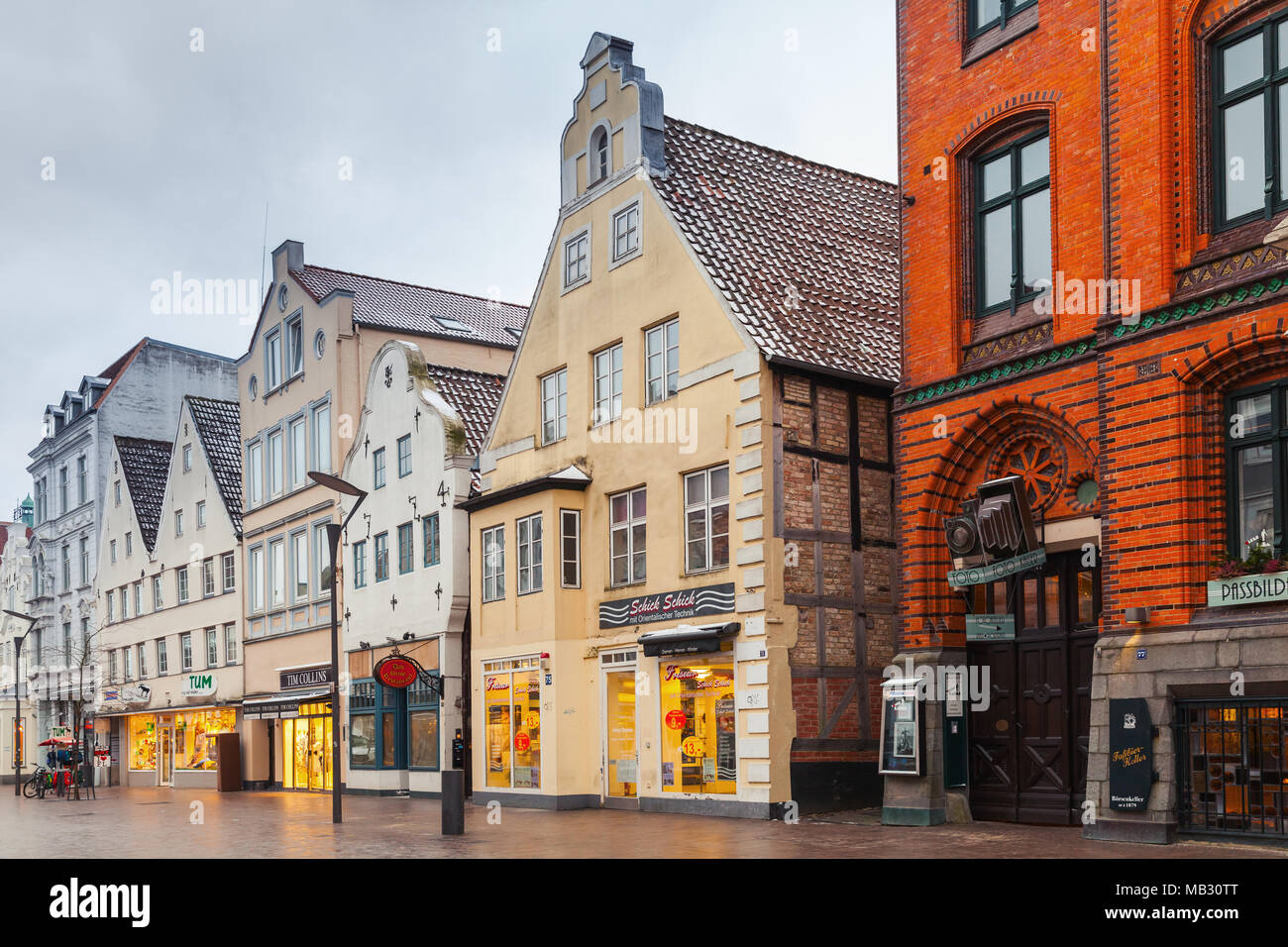 Flensburg, Germany - February 8, 2017:  Grosse Strasse street view in evening. It is a shopping street in center of the city, which continues course o Stock Photo