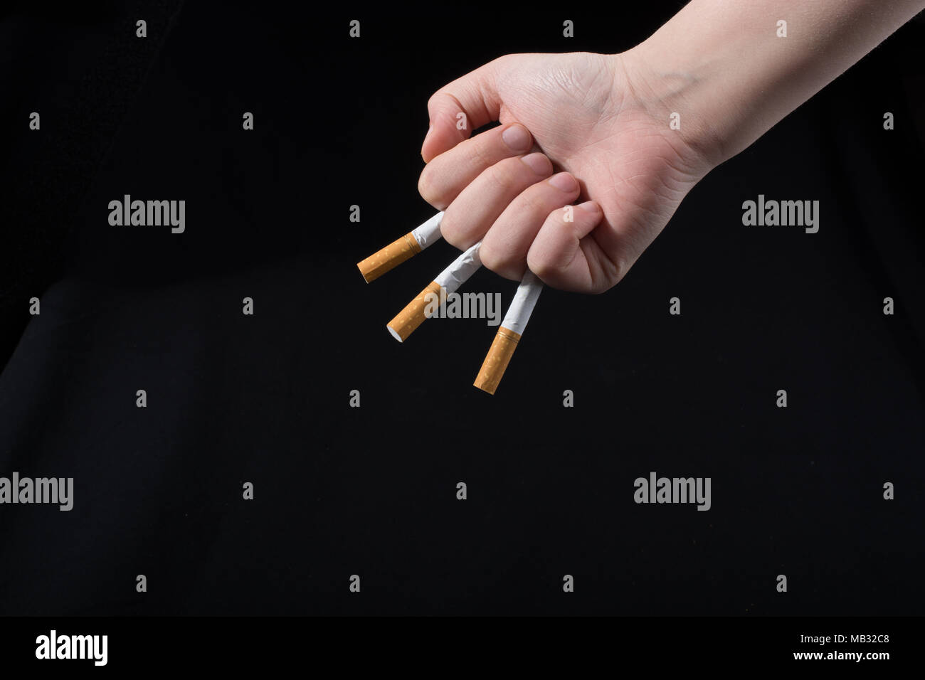 cigarette between middle and ring finger Holding cigarette between fingers hi-res stock photography and images