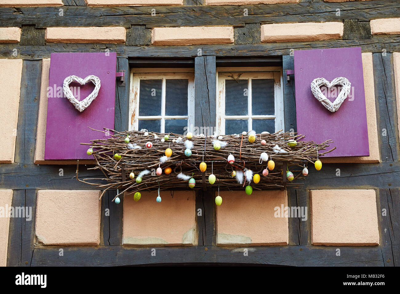 Window with easter decoration, old half-timbered house in the old town, Riquewihr, Alsace, France Stock Photo