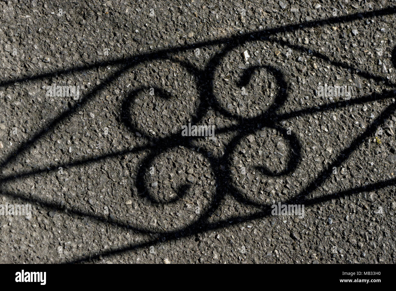 Shadow of gate on drive Stock Photo