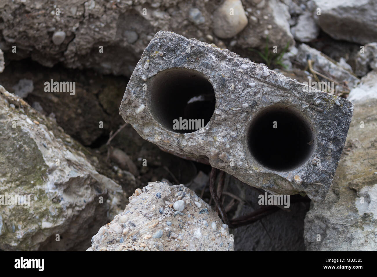 Detail of a broken concrete at a junkyard, which looks like eyes of an animal. Stock Photo