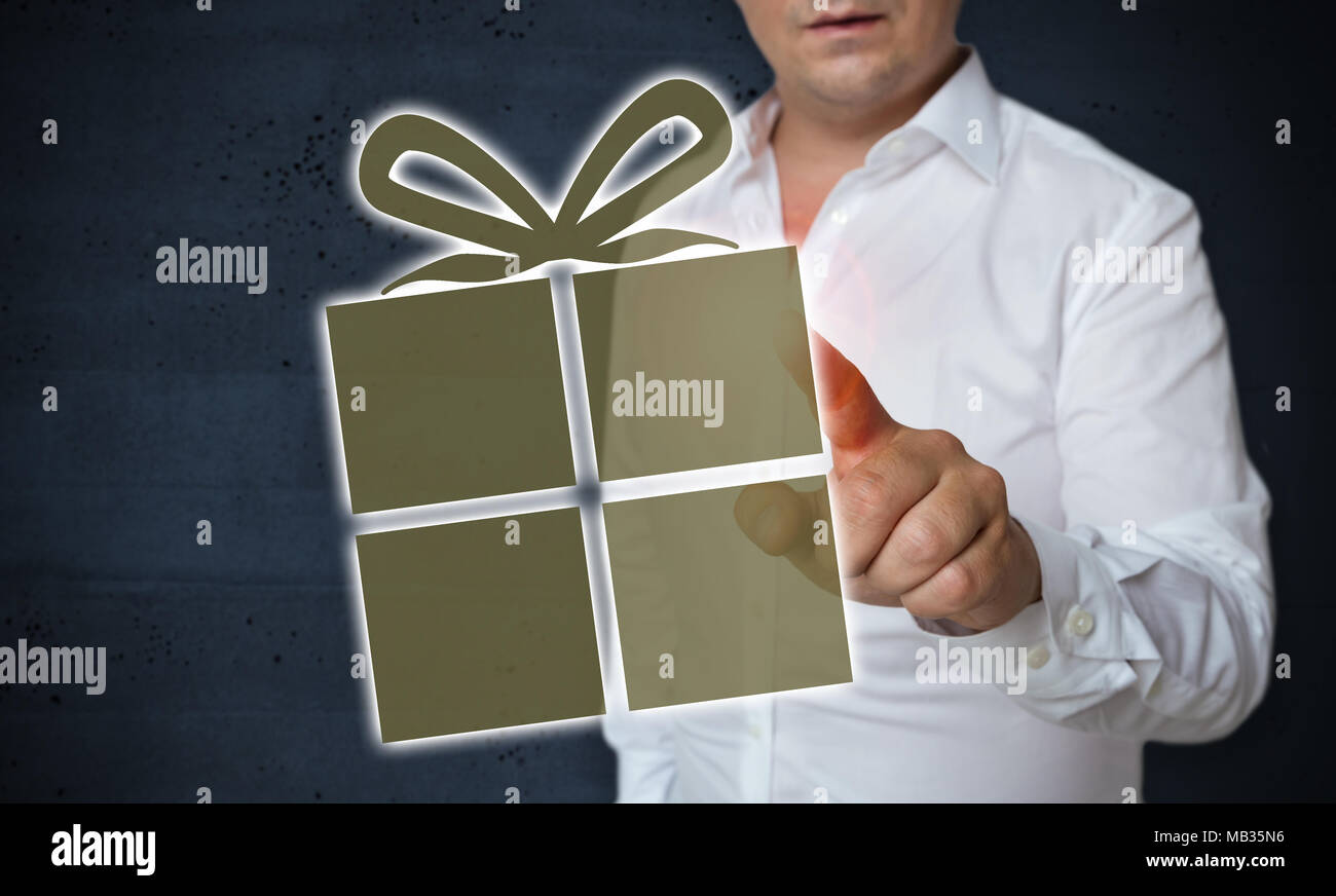 Gift Icon Touchscreen is operated by man concept. Stock Photo