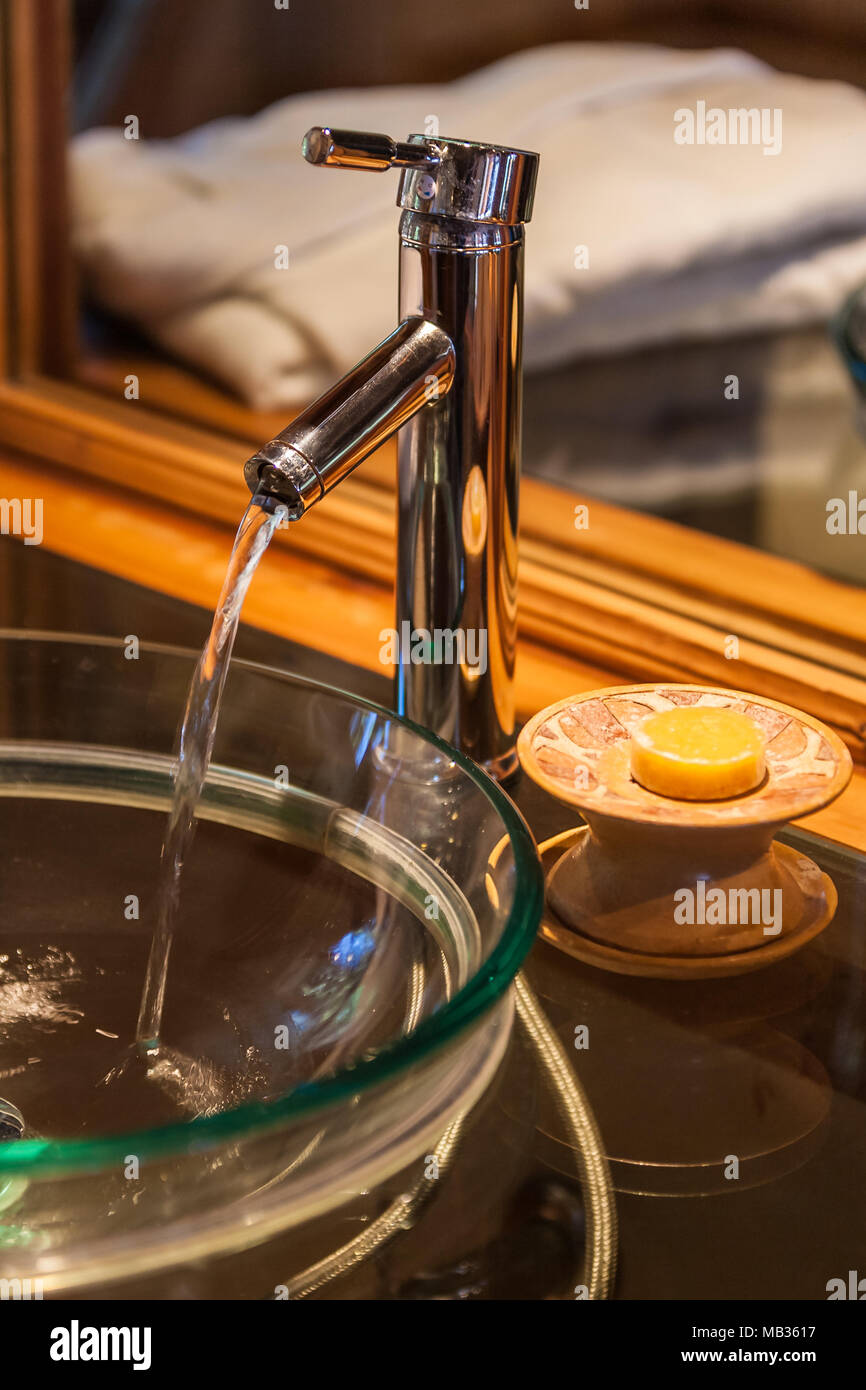 Tap flowing in a luxurious hotel room bathroom Stock Photo - Alamy