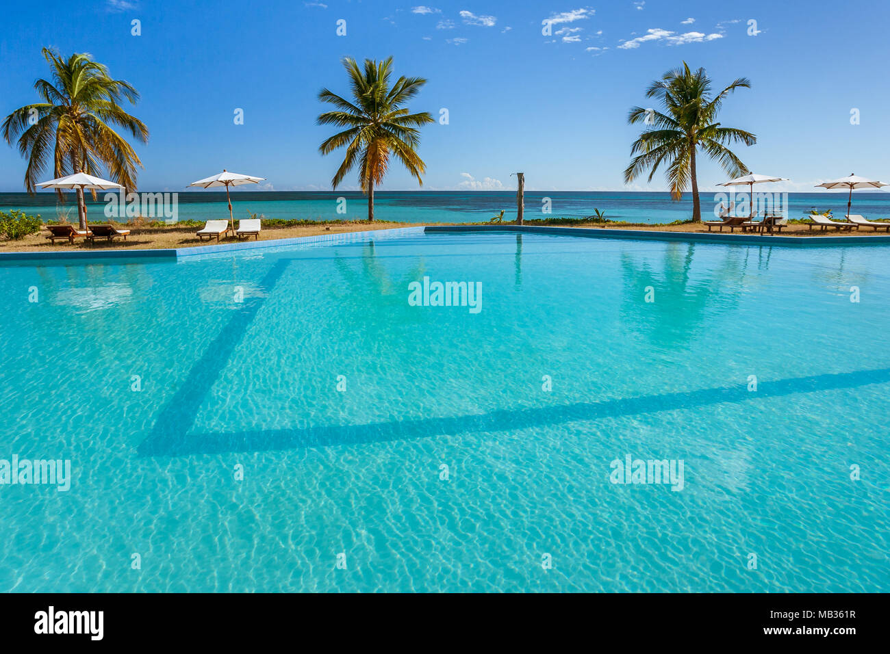 Tropical swimming pool overlooking the sea Stock Photo