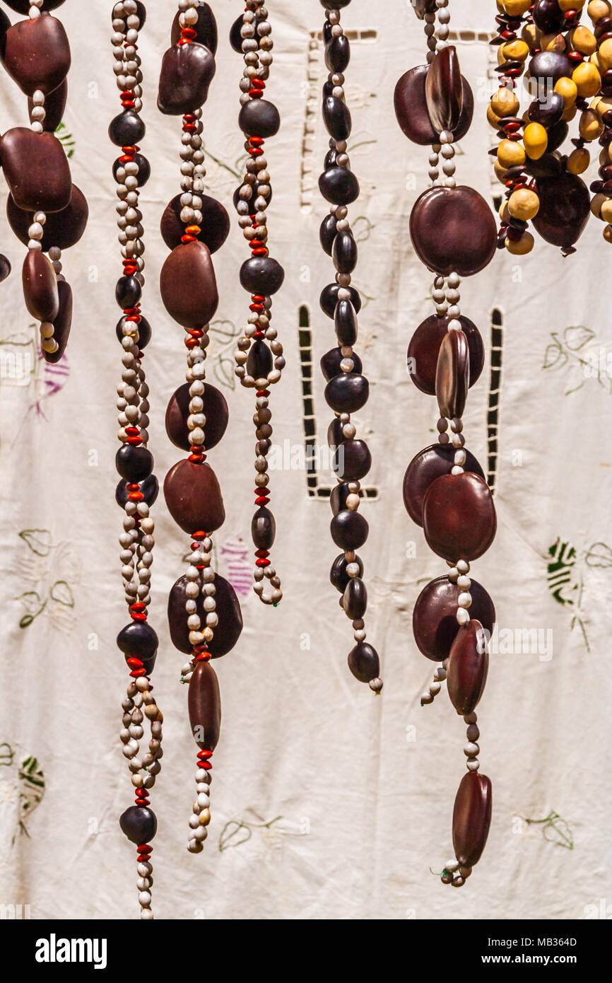 Crafts embroidered tablecloths and necklaces seed in Nosy Komba (Nosy Be), Madagascar Stock Photo