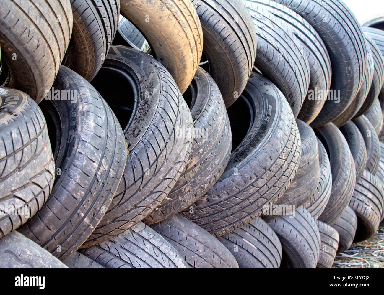 wall of worn out car tyres waiting for disposal to a recycling centre