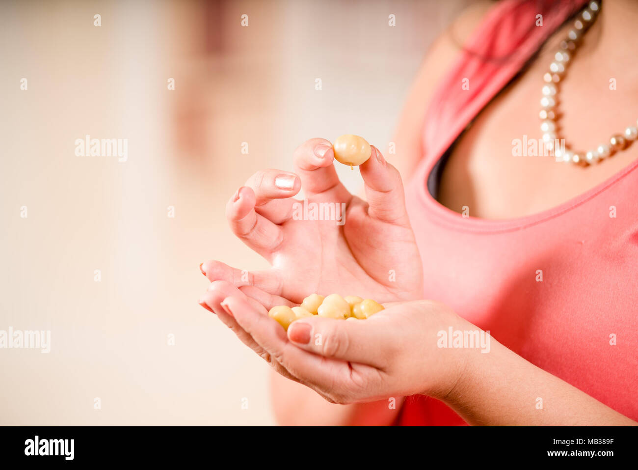 Close up of woman holding in her hands a star gooseberry fruit. Phyllanthus acidus, known as the Otaheite gooseberry, damsel, grosella Stock Photo