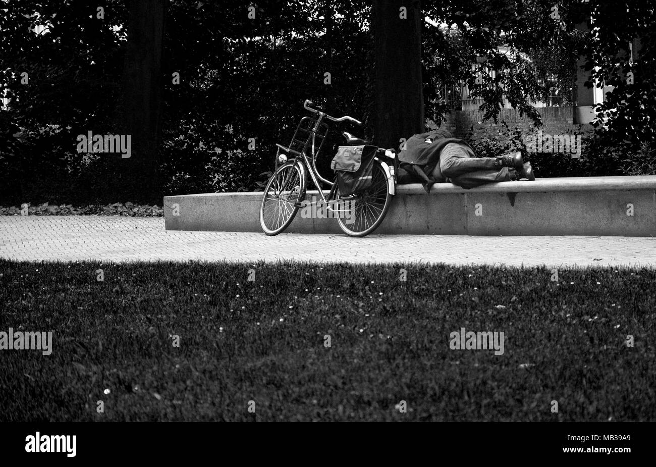 Cyclist having a sleep in the park, 'S-Hertogenbosch, The Netherlands Stock Photo