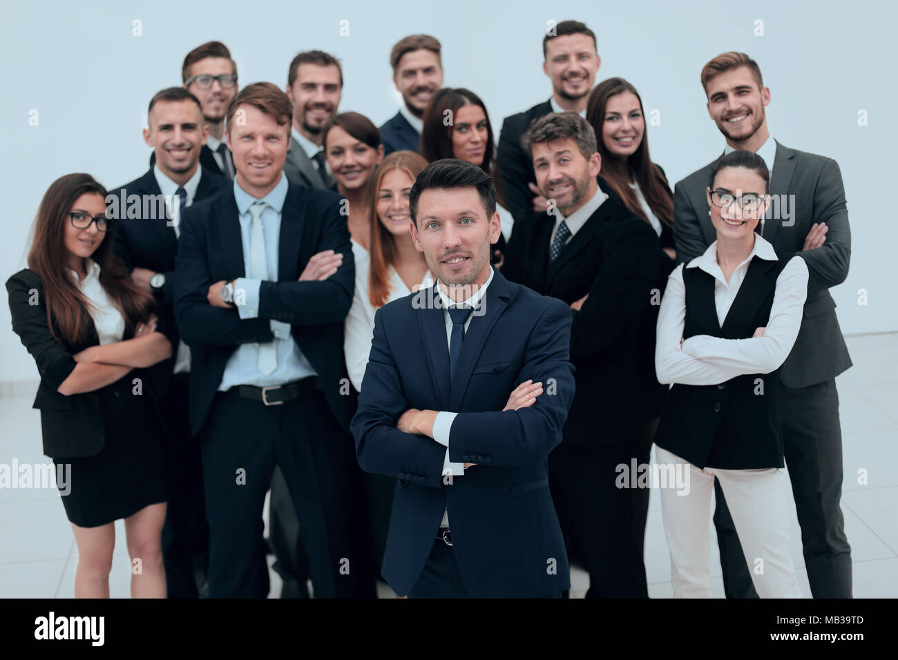 leader standing in front of a large business team Stock Photo - Alamy