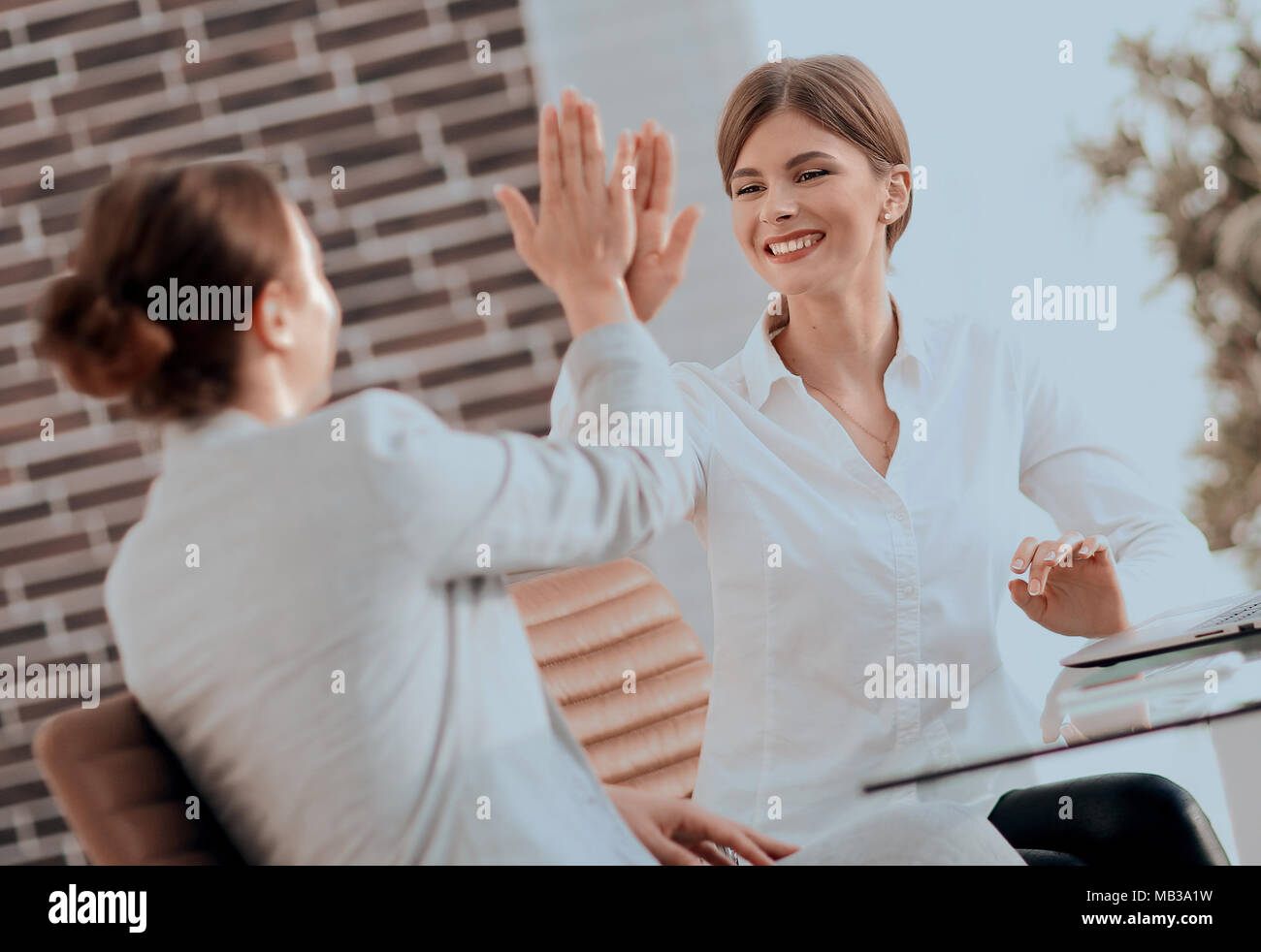 members of the business team giving each other a high five Stock Photo ...