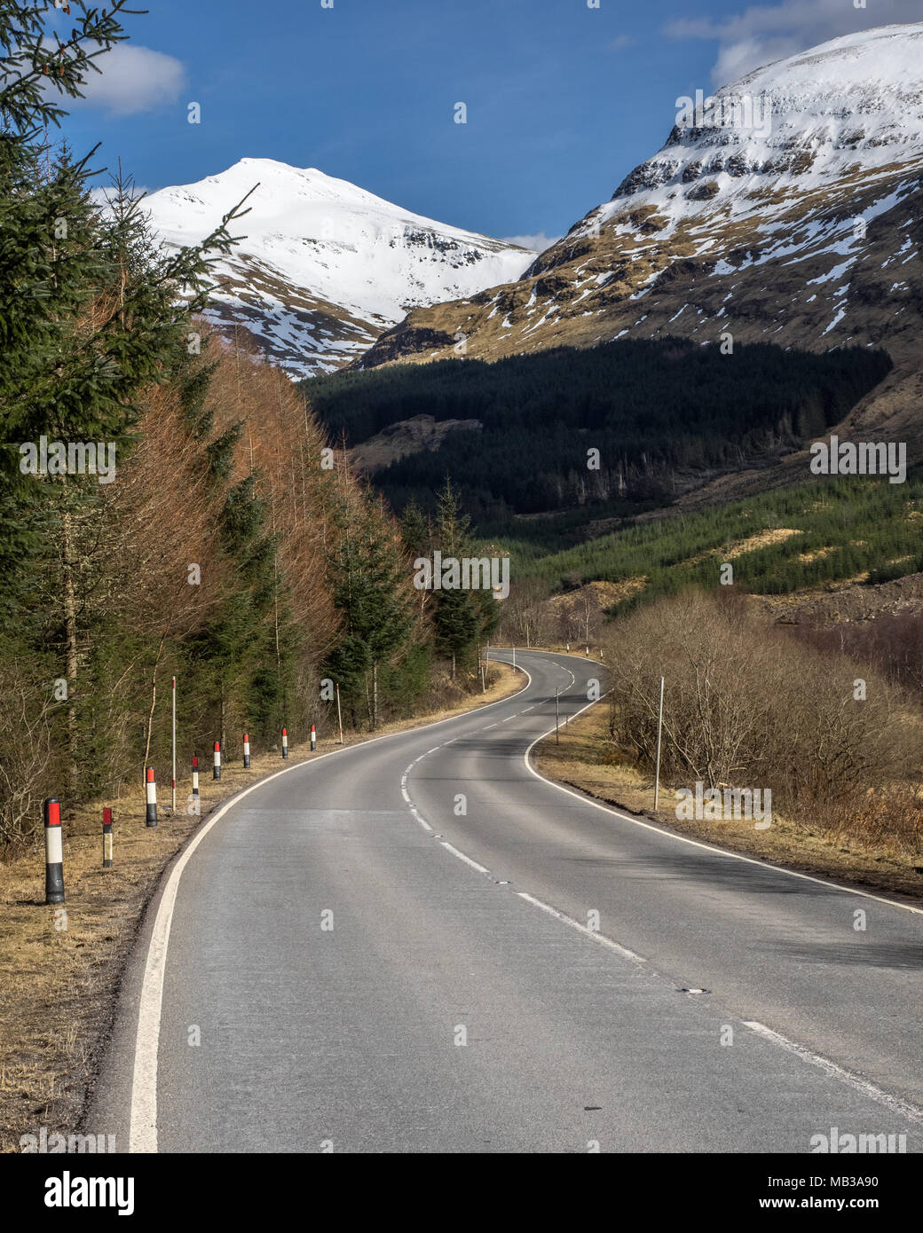 Looking up to a snow capped Ben Lui from the main A85 road through Glen Lochy in Scottish Highlands Stock Photo